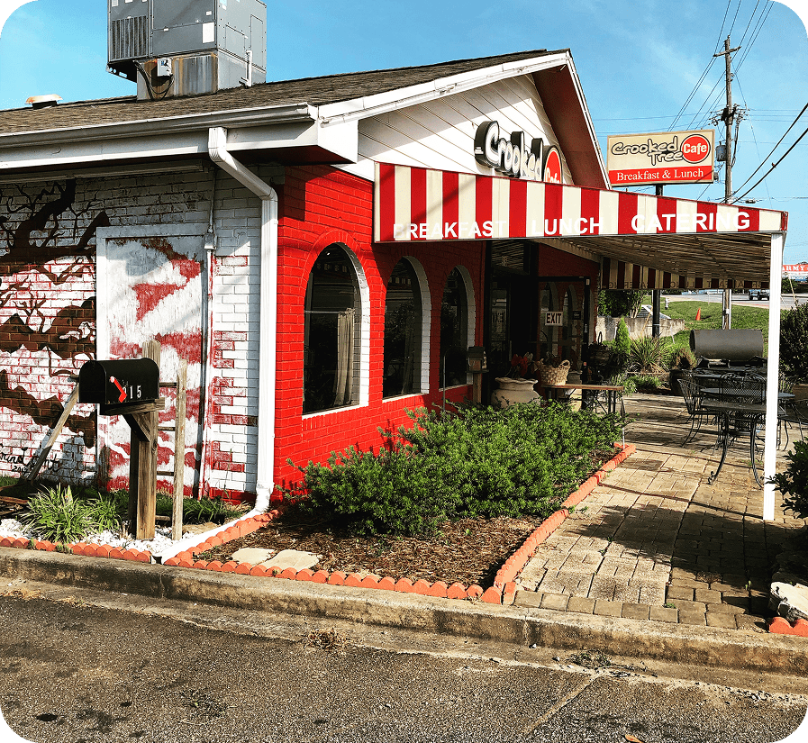 Red and white striped awning over cafe.
