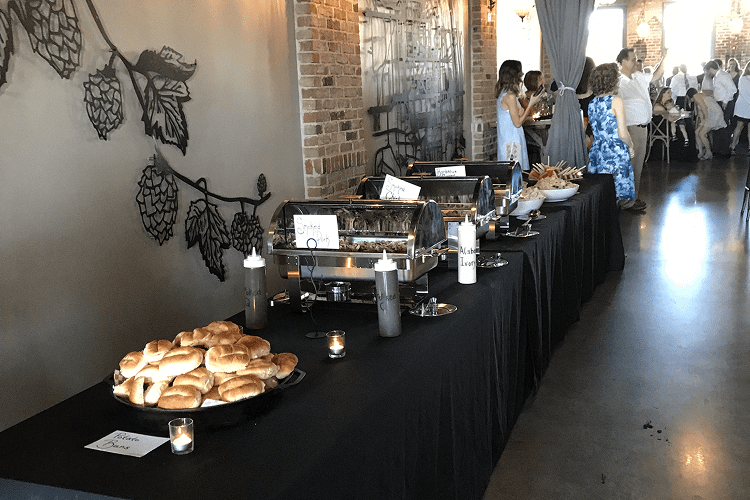 Buffet table with bread and condiments.