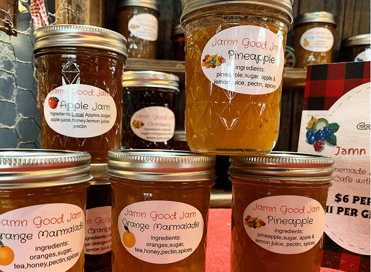 Jars of assorted homemade jams on display.